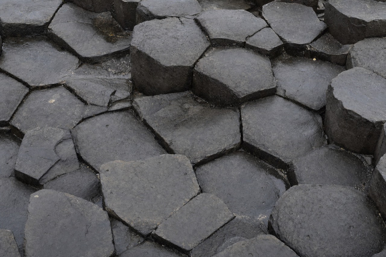 Close view of the hexagonal tops of the Gardar basalt columns at Reynisfjara, forming a natural staircase